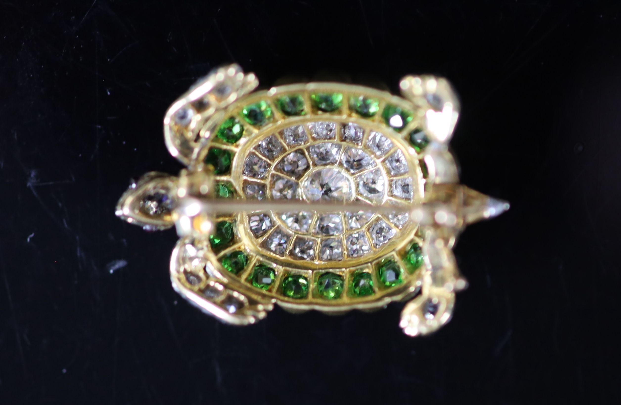A platinum, pave set diamond and demantoid garnet set tortoise brooch